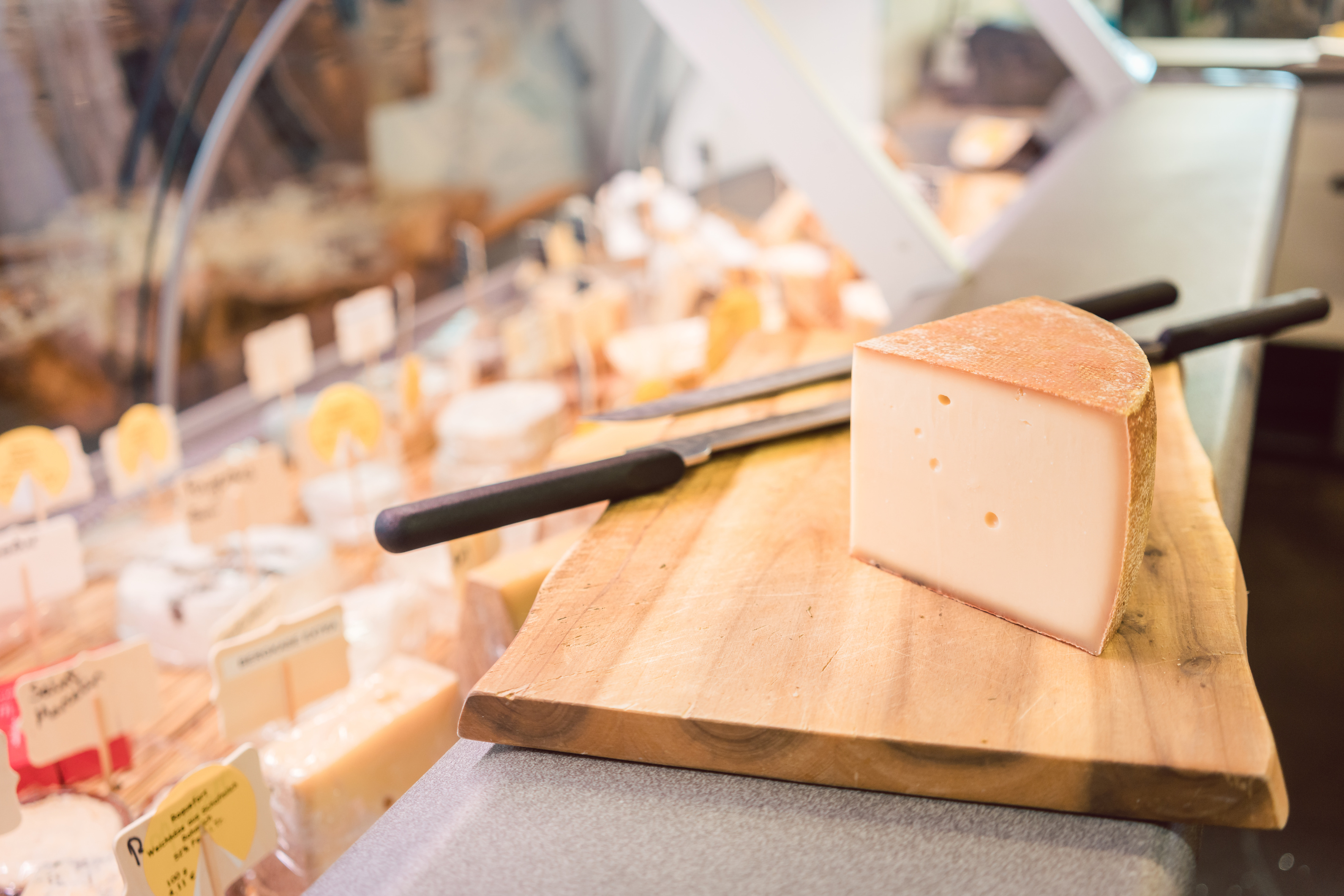 Cheese on a Board at Counter in Delicatessen Shop